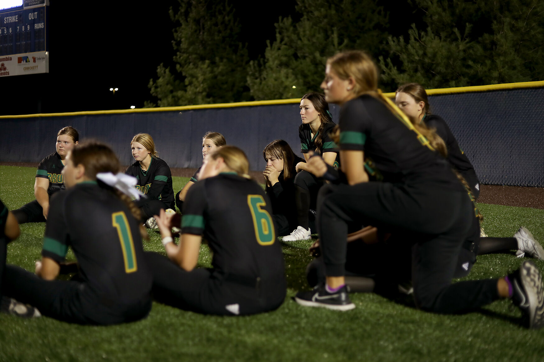 The Rock Bridge softball team listens to their coaches speak